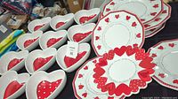 Image of dishware including heart-shaped bowls and octagonal plates with red heart designs