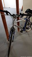 Front angled view of silver and blue Cannondale Sportride bicycle showing frame, handlebars, and front wheel.