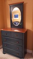 Front view of dresser and attached oval mirror