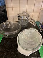 Photo showing entire lot with Pyrex double boiler, clear glass casserole dish and ovenproof dish on kitchen counter.