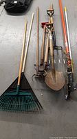 All garden tools laid out on floor showing handles and tool heads