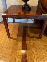 Photo from a side angle showing the table structure, leg design, and wood grain.