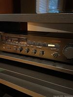 Close-up front view of Yamaha RX-500U stereo receiver showing multiple buttons, knobs, and tuning dial