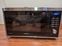 Full frontal view of the Samsung Smart Oven showing the door and control panel