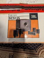 Original JBL Simply Cinema SCS135 packaging showing model and brand