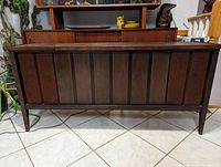 Front view of the stereo console showing the wood paneling and speaker grilles