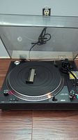 Fully assembled PR96 record player with clear dust cover open, showing platter and tonearm.