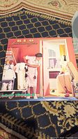 Front cover of REO Speedwagon Good Trouble album with woman in maid outfit in domestic scene.