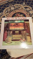 Front cover of vinyl album showing jukebox and title "Best of the Doobies".