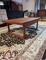 Table shown in extended position with teak grain visible
