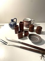 Photo showing Danish pottery jug, wooden candle holders, salt and pepper shakers, small ceramic dish and BBQ utensils.