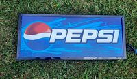 Front view of the vintage Pepsi illuminated sign showing the logo and text on a blue background.