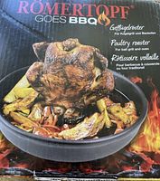 Box showing Romertopf poultry roaster for ball grill and oven with a cooked poultry image.