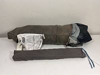 Full view of the folded Coleman Eagle Rock dome tent inside a storage bag along with a separate smaller bag, likely containing stakes or accessories.