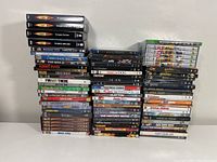 Stack of various DVDs including Doctor Who complete series and other DVDs including some sealed cases.