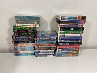 Overall view of three stacks of DVDs and VHS tapes with visible titles