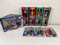 Full lot with Star Trek boxed set, DC superhero figures in boxes (Wonder Woman, Harley Quinn, Joker with corner box damage, Batman) and Star Trek mini figures and shuttle in blister packs.