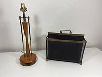 Full view of the lamp and magazine rack together against a white wall