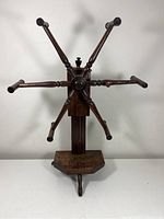 Front view showing the six turned arms on the yarn winder and tripod base