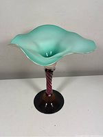 Front view of full vessel showing ruffled bowl top, twisted stem, round foot