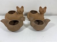 Front view showing 2 cat and 2 chicken unglazed stoneware planters