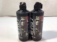 Front view of two black 118ml bottles of M-Pro 7 Copper Remover with labels showing firearm image and text.
