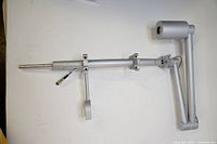 Full view of the silver telescoping pole assembly with swivel boom and cylindrical camera mount.
