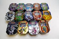 Full display of 14 assorted Pokémon TCG collectible tins arranged and showing front artwork.