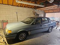Front passenger-side three-quarter view in garage