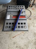 Top view of Ryobi table saw showing metal surface, red blade slot, and blue rip fence.