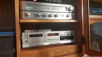 View of Toshiba SA-220C receiver and Akai dual cassette tape deck inside wooden cabinet
