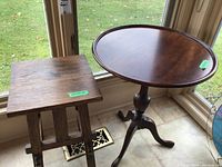 Photo showing side table and wooden stool together by window