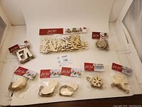 Full display showing 8 items including wooden sleigh set and 7 varied garland packages with tags, all new