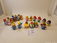 Front overview shot showing all Disney Little People figures and Cars vehicles arranged on white background with label.