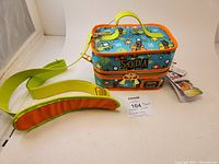 Scooby-Doo Loungefly cooler bag on white surface showing full cooler and attached yellow strap