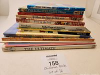 Pile of 16 children's books stacked showing spines of titles such as Willy Whyner, Fish do the Strangest Things, It Must Be Nice to Be Little, Five in the Bed, Twelve Days of Christmas, Peter Rabbit's Lift-the-Flap, Disney Ratatouille, and The Ultimate Peter Rabbit.