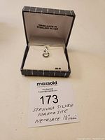 Necklace in box with label showing 'Marcasite in Sterling Silver' and price tag.