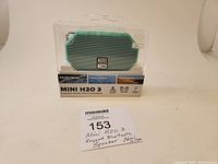 Mini H2O 3 Bluetooth speaker in original packaging showing front and packaging details including waterproof, snow proof, and dirt proof features.