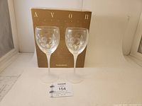 Two Avon crystal goblets displayed in front of original Avon box, showing the overall items and packaging.