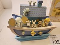 Front view of Precious Moments Noah's Ark wooden figurine with multiple animal figures including elephant and rabbit