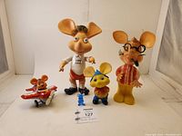 Full set of four vintage Topo Gigio dolls and toy plane, showing relative sizes and condition.