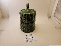 Full frontal view of the vintage asparagus cookie jar with lid showing detailed asparagus stalk texture and tip handle.