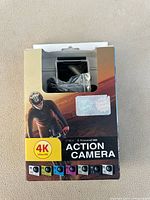 Front of box showing the action camera inside with cyclist image and 4K Ultra HD label.