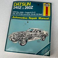 Front cover of the Haynes Datsun 240Z & 260Z automotive repair manual with blue background and illustration of car.
