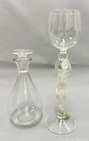 Photo of the clear glass decanter with stopper and the 8-inch stem bar glass featuring a frosted nude female figure.