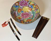Photo of the two katana letter openers with hand-carved and painted geisha handles, four pairs of walnut chopsticks, and the mille fleur floral serving bowl.