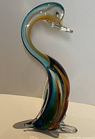 Side profile view of the Murano Sommerso swan sculpture showing color transitions and curved neck.