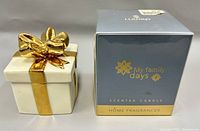 Lladró scented candle next to the decorative porcelain gift box, showing the candle box front and gift box details.