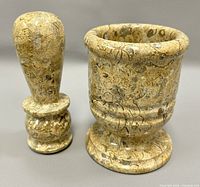 Mortar and pestle displayed separately showing jasper stone patterns and shape