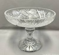 Front view of the vintage crystal pedestal bowl showcasing detailed pinwheel cut pattern along the edge and clear thick crystal with rounded pedestal base.